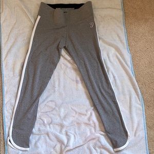 Grey leggings with white stripe down the side.